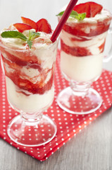 fresh strawberries with whipped cream and mint on the table