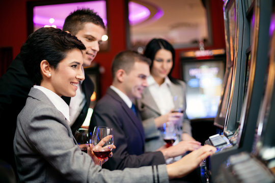 people gambling on slot machines