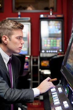 man concentrate on slot machine