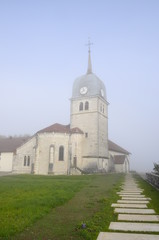 Fototapeta na wymiar Abbey church in Jura, France and cure (house of the priest).