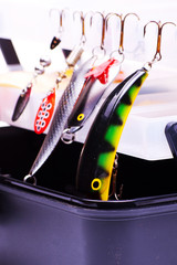 Fototapeta premium Opened fishing box with lures on a white background