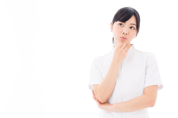 attractive asian nurse thinking on white background