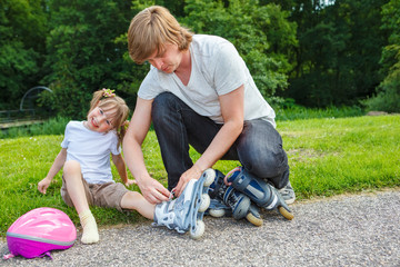 Father helping preschool daughter