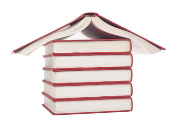Stack of books forming the shape of a house isolated on white