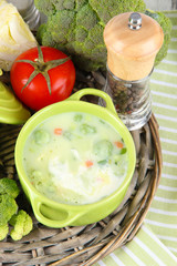 Cabbage soup in plates on braided tray on napkin on wooden