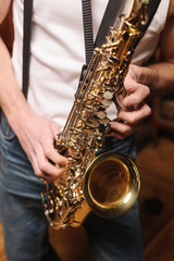 Obraz premium Men playing saxophone. Close up of men playing saxophone