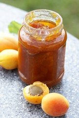 Glass with apricot jam and fresh apricots