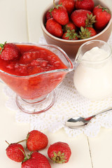 Homemade strawberry jam, on  napkin, on color wooden background