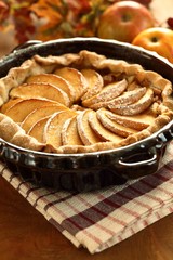 Arrangement of home-made apple pie and apples.