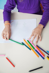 Girl With Color Pencils And Paper At Desk