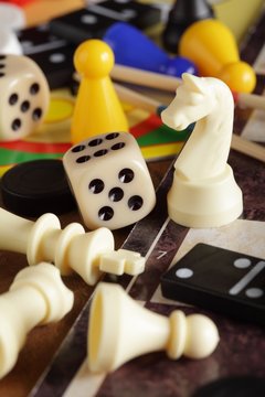 Detail of board games, pawns, chessmen, dominoes and dices.