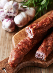 Dried sausage on wooden chopping board (polish cuisine)