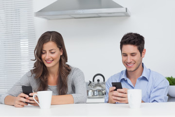 Couple using their smartphones