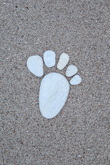 stone foot prints on sand