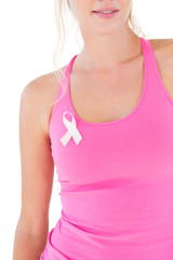 Woman wearing pink top and breast cancer ribbon