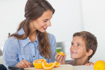 Obraz na płótnie Canvas Little boy eating orange segments