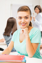 happy smiling student girl with books at school