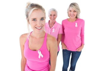 Three generations of women wearing pink tops and breast cancer r