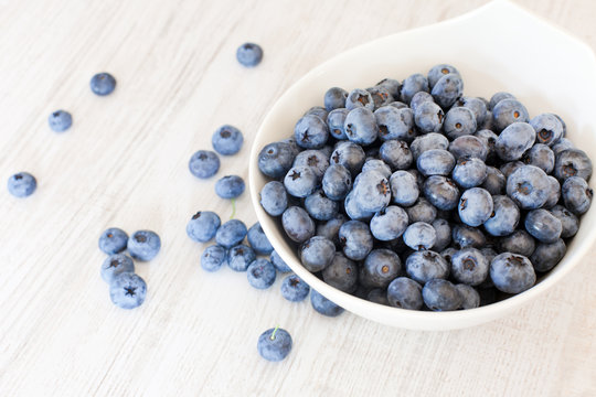 White bowl cup with fresh ripe blueberries