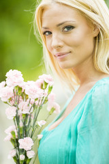 Young blond woman with flowers