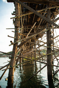 Wooden pillars of the bridge mon