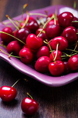 fresh cherries on wooden plank