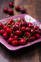 fresh cherries on wooden plank