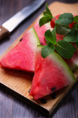 slices of watermelon on an old wooden plank © Kamila Cyganek