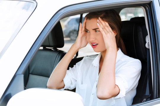 Troubles on the road, girl touches her forehead by hands