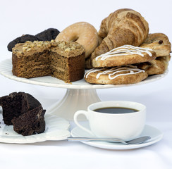 Continental breakfast buffet table setting with coffee and pastr