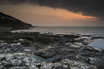 Sunrise over rocky coast ocean landscape