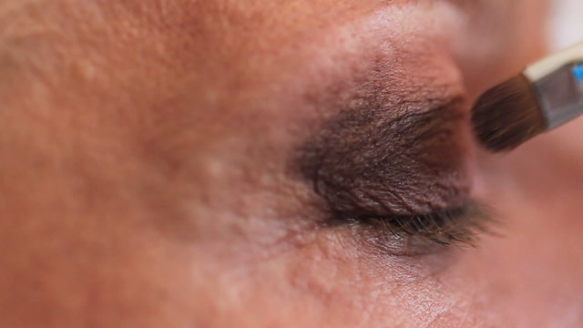 Esthetician - Closeup woman having applied makeup by makeup arti