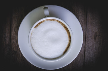 cappuccino coffee on wooden table