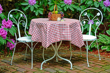 table and chairs in rhododendron garden