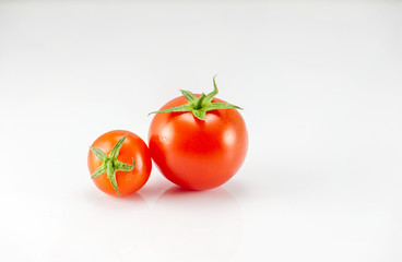 Two tomatoes on the white background