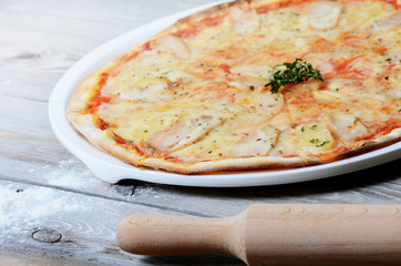 Sweet pizza with a chicken and pineapples