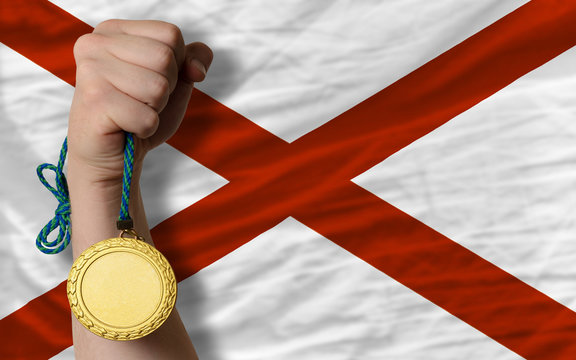Gold medal for sport and flag of american state of alabama