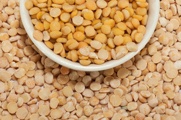 Wet pea groat in a bowl on a background of dry pea groats
