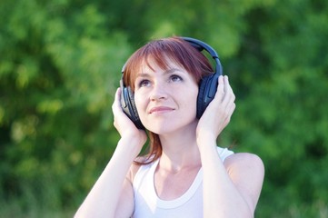 happy woman outdoors in wireless headset