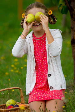 Orchard, harvest - funny young girl with picked ripe pears