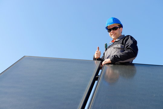 Man installing alternative energy photovoltaic solar panels
