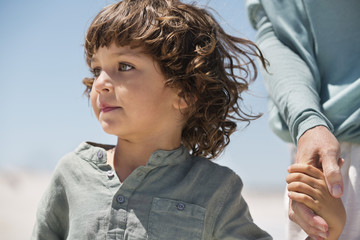 Boy holding hand of his grandmother