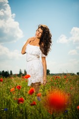 Beautiful young brunette girl in poppy filed