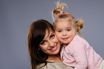 Happy young mother hugs her daughter