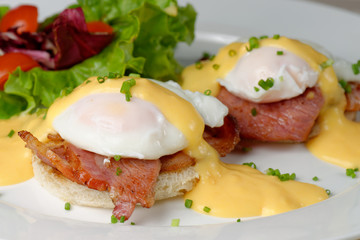 Eggs Benedict- toasted English muffins, ham, poached eggs © Visionsi