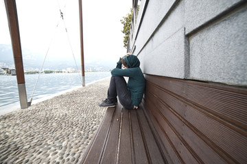 sad woman on a lakeside