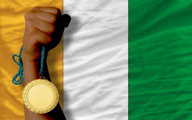 Gold medal for sport and  national flag of cote ivore