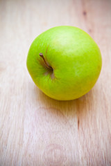 green apple on a wooden background