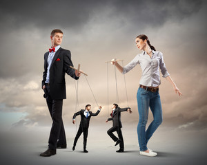Businesspeople with marionettes