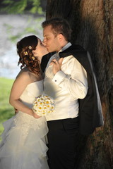 young wedding couple kissing, beautiful bride with groom